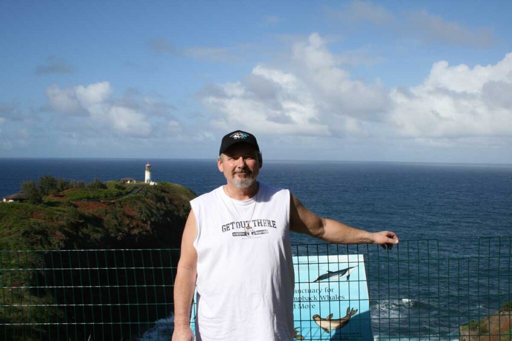 man standing with ocean in back